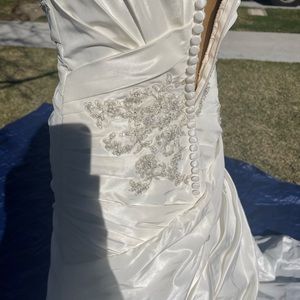 Size 4 wedding dress with a few minor spots on the underside of the train.
